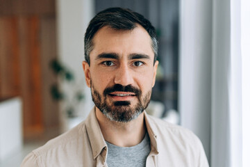 Man with beard smiling looking at camera