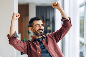 Naklejka premium Happy man celebrating success achieving victory