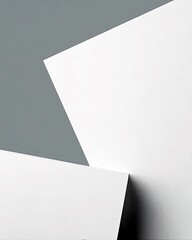 A minimalist abstract composition featuring intersecting planes of white and a gray background, creating a clean and modern aesthetic.