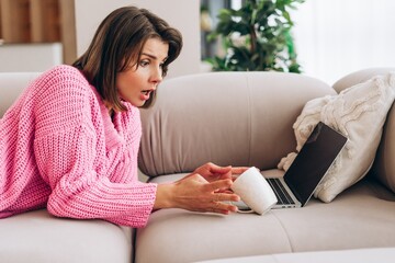 Woman spilling coffee on laptop, causing an accident