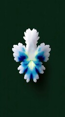 A single, intricately shaped flower petal with vibrant blue markings against a deep green backdrop.