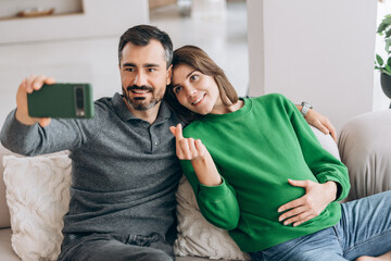 Pregnant couple taking selfie showing love and family bonding