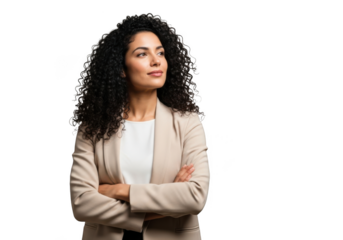 Confident professional woman with curly dark hair wearing a beige blazer arms crossed looking thoughtfully to the side isolated on transparent background