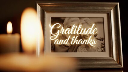 Image of a smiling senior man and woman in a photo frame with glowing candles, then overlaid with Gratitude and thanks for a video.