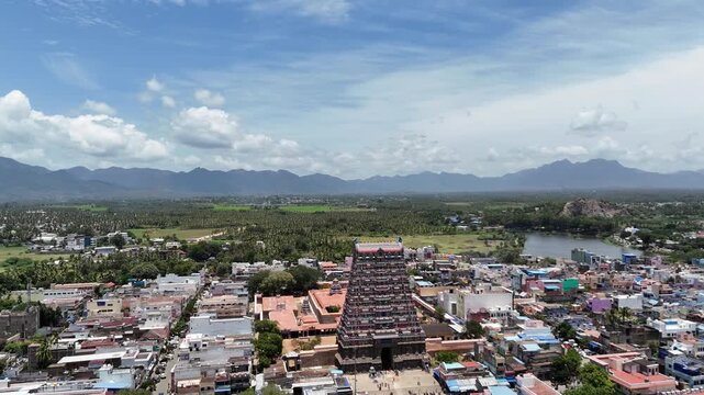 Aerial footage of Tenkasi&rsquo;s iconic Kasi Viswanathar Temple rises above bustling streets, surrounded by vibrant fields and hills under a wide, blue sky.