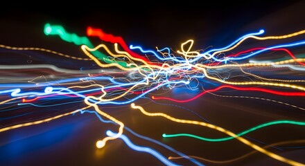 Abstract image of colorful light trails created by moving lights in a dark environment, producing dynamic and vibrant streaks of various colors and shapes