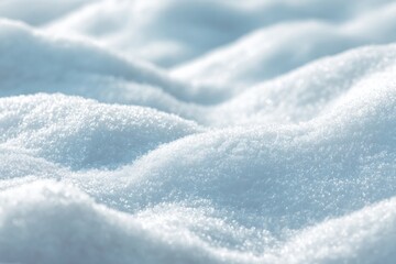 Close-up of soft, untouched snow with sparkling texture under sunlight.