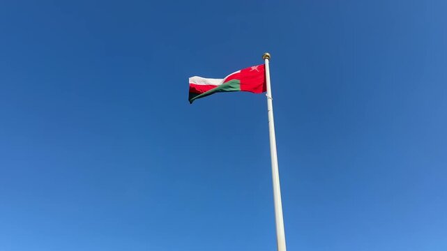 Oman Flag Blowing in Wind 4K Blue Sky Middle East Gulf The Sultanate of Oman National Flag Waving Outdoor Footage