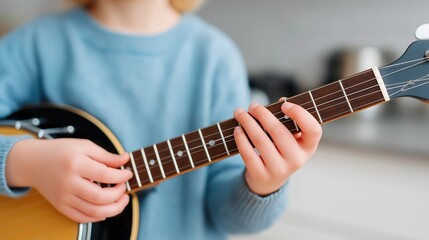 Child Learning Ukulele At Home Close-Up