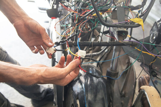 Caucasian electric repairing motorcycle electrical system.