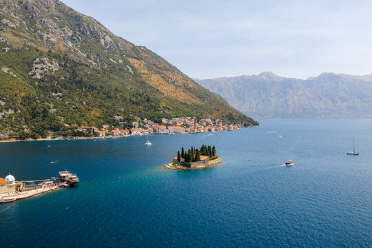 Aerial view of the captivating blend of deep blue sea and verdant islet Sveti Dorde and Church of our Lady of the Rocks, Perast, Kotor Municipality, Montenegro.