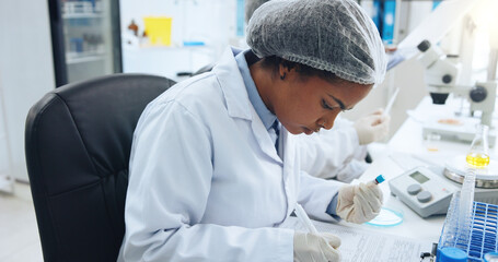 DNA, writing and science with woman in laboratory for medical development or research. Blood sample, notebook and observation with doctor at work on clinical trial, investigation or pharmaceuticals