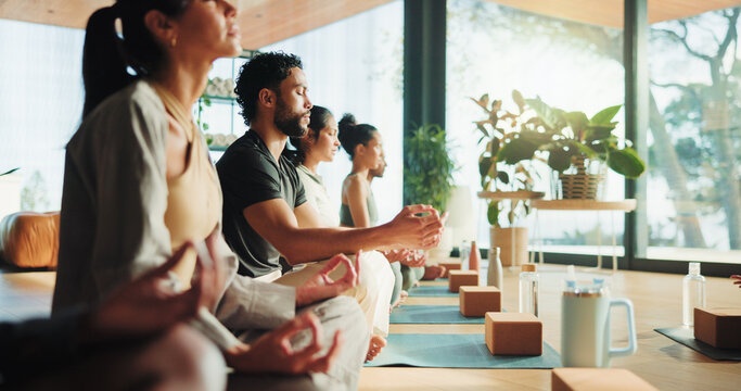 Zen, people and calm in yoga class with lotus pose for meditation, chakra healing or wellness. Group, relax or yogi in health studio with mindfulness exercise for inner peace, community or awareness.