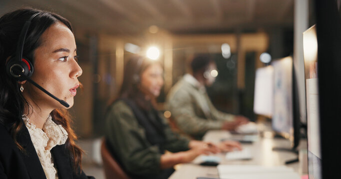 Woman, call center and helpdesk with headset at night for customer service or consulting at office. Female person, employee or agent talking for communication, typing and overtime at workplace - Powered by Adobe