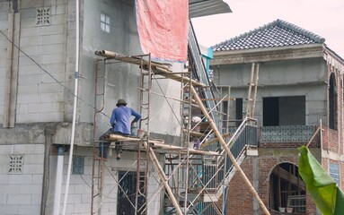 Realistic View Man Plastering Wall on Scaffolding for Building Construction