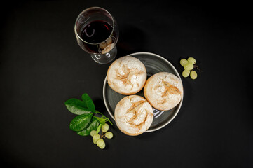 Pumpkins and freshly baked buns on black background