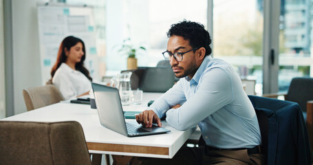 Reading, info and man with laptop in office, serious and research for wealth management and...