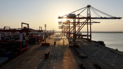 Unloading large cargo containers seaport. Loading freight sea port. Top aerial drone view. Lot big boxes rows, ship delivery ocean harbor. Industrial Shipping day. Goods export import. Marine dock.