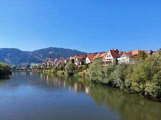 river Mur and old town Frohnleiten under blue sky. Sunny day. Austria