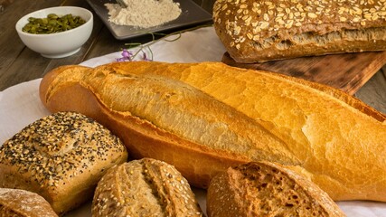 Fresh baked artisan bread and rolls with ingredients for baking
