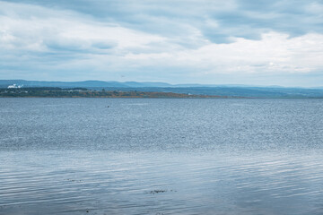 View across coastal firth to village
