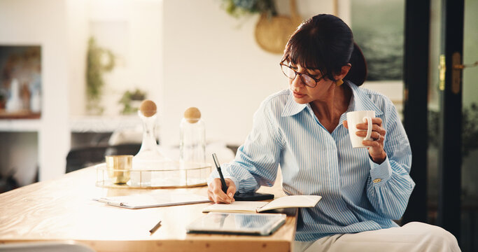 Woman, writing and notebook with coffee at house for planning, finance reminder and payment timeline. Mature person, beverage and notes of household budget, tracking expenses and financial management