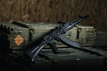 assault rifle placed on identified ammunition box displaying hazard and identification labels