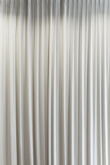 White vertical curtains, interior, theater curtain that dropped down as a straight line. Background for inserting text, empty spaces