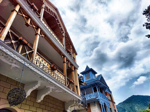 Historical buildings under a dramatic sky in a scenic mountain town