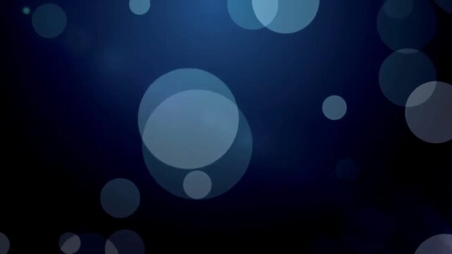 Dark blue abyss background with large abstract bokeh light particles slowly moving up