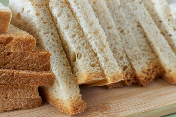 sliced bread on wooden plate, close up image with selective focus