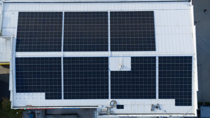 Aerial view of rooftop solar panels on industrial building, clean renewable energy technology for sustainable power generation