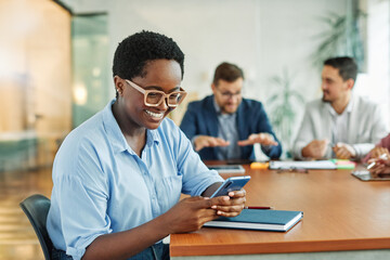 Portrait of a group of young business people having a meeting in the office. Teamwork and success concept, portrait of a smart young businesswoman using a smartphone phone and texting