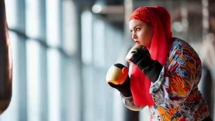 Empowered Focus: A Determined Individual in a Vibrant Outfit Training with Resilience and Skill Against a Heavy Bag, Representing Strength and Perseverance in Martial Arts