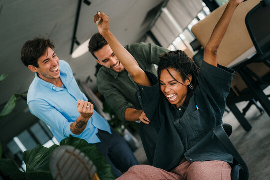 Joyful, excited diverse entrepreneurs are celebrating their success and the great work environment - Powered by Adobe