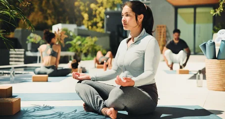 Fotobehang Lotusbloem Relax, lotus pose and woman at yoga class outdoor with break, calm or peace at wellness retreat. Zen, breathe and female person at meditation session for health, self care or balance with mindfulness  © peopleimages.com