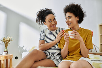 Happy African American lesbian couple enjoying quality time at home together