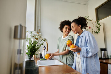 Happy couple enjoying quality time in their cozy modern apartment while cooking