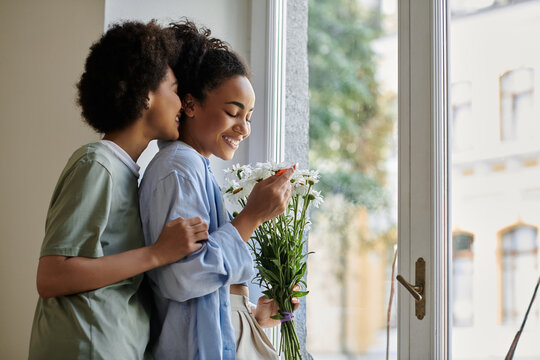 Joyful African American couple sharing love and laughter in their modern apartment - Powered by Adobe