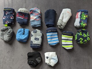 A neat pile of colorful toddler socks stacked together for a three-year-old child.

