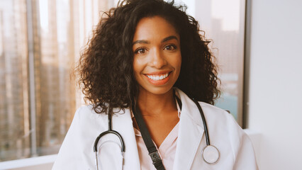 Portrait Of Smiling Female Doctor Wearing White Coat With Stethoscope In Hospital Office