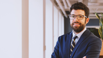 Portrait Of Smiling Mature Businessman In Modern Office