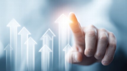 A hand pointing at upward arrows, representing business growth and success.