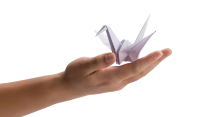 origami crane gracefully resting on an open palm . Isolated on transparent background, png