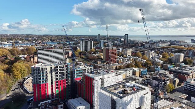 A construction site dominated by cranes , emphasizing growth and the evolution of the urban landscape in modern cities in London UK