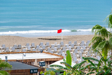 Beach promenade with palms, tropical beach scenes, historic peninsula Alanya, seaside view palm trees, colorful sunbeds and umbrellas, resort Turkey locations, calm ocean waves and tranquil sky