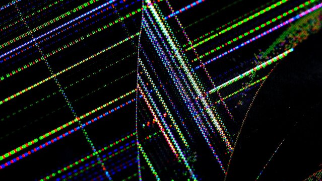 Detailed view of a damaged TV screen showing colorful lines and pixel distortion, illustrating technology failure.