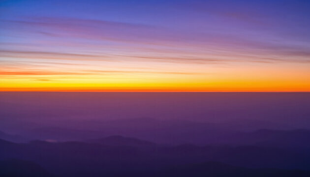 Serene mountain-horizon at twilight, showcasing a soft purple-orange gradient background, warm dusk glow, and smooth color transition across the tranquil evening sky