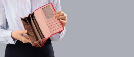 Bankrupt businesswoman with empty wallet on light background, closeup