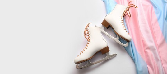 Ice skates with transgender flag on white background with space for text
